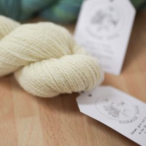 A close-up of a skein of natural cream coloured yarn