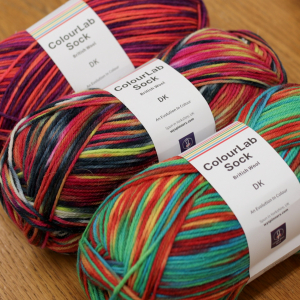 Three balls of DK sock yarn, in variegated colour-ways