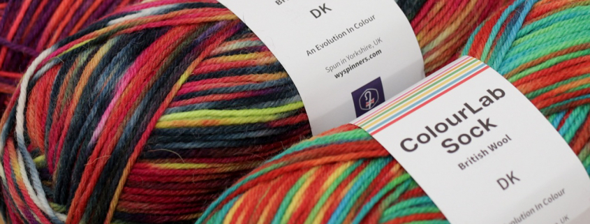 Three balls of DK sock yarn, in variegated colour-ways