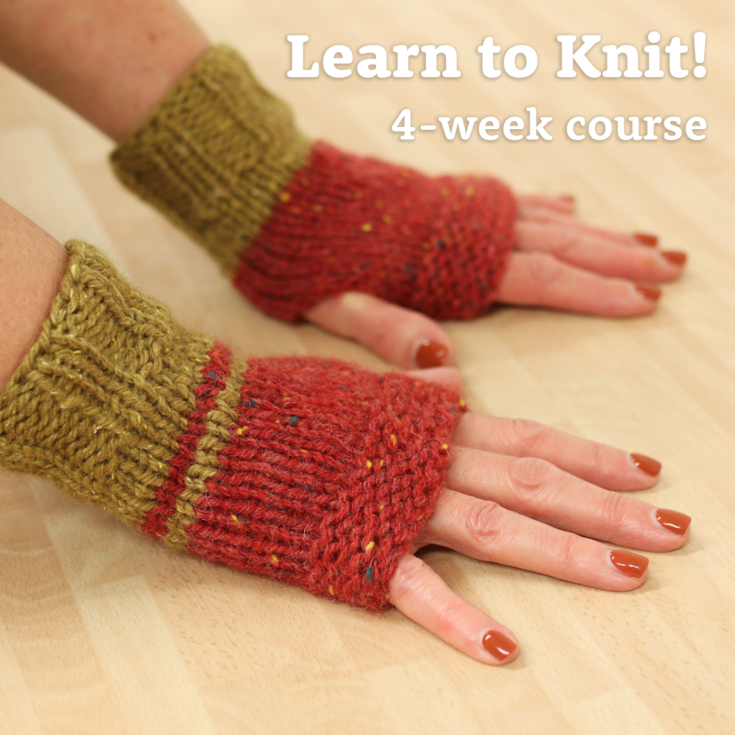 hands modelling hand-knitted fingerless mittens in 2 colours